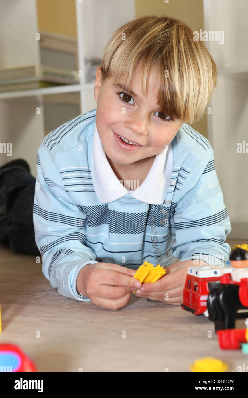 Little boy playing with toys Stock Photo - Alamy