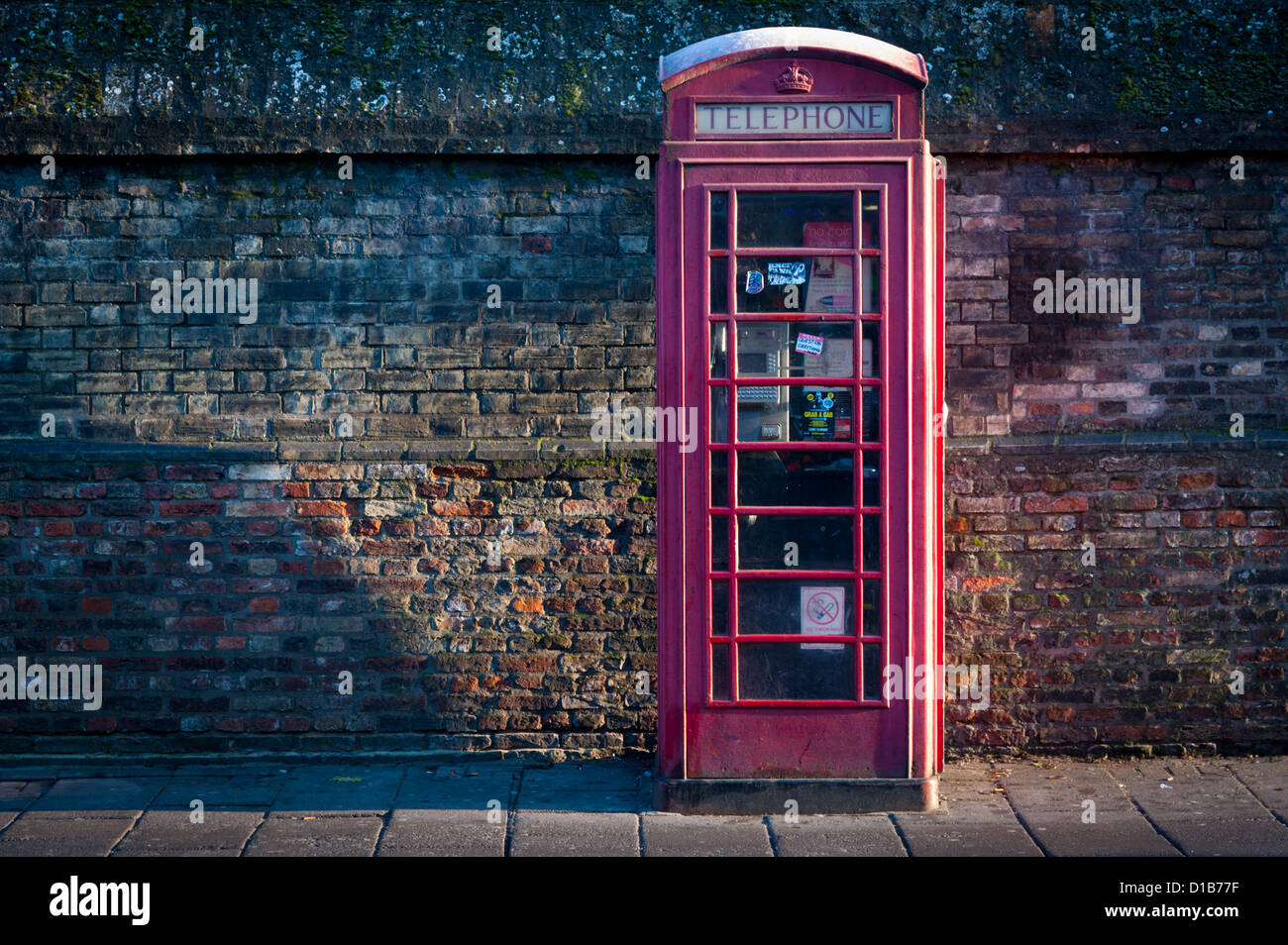 Traditional red telephone box Regent Street Cambridge UK in sidelight Stock Photo