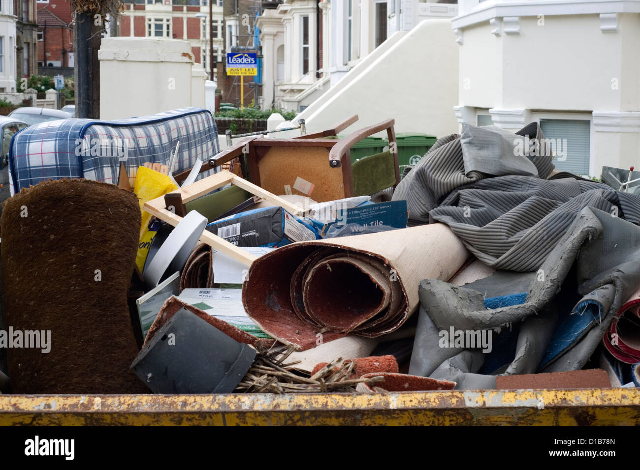 large skip full of household domestic rubbish Stock Photo