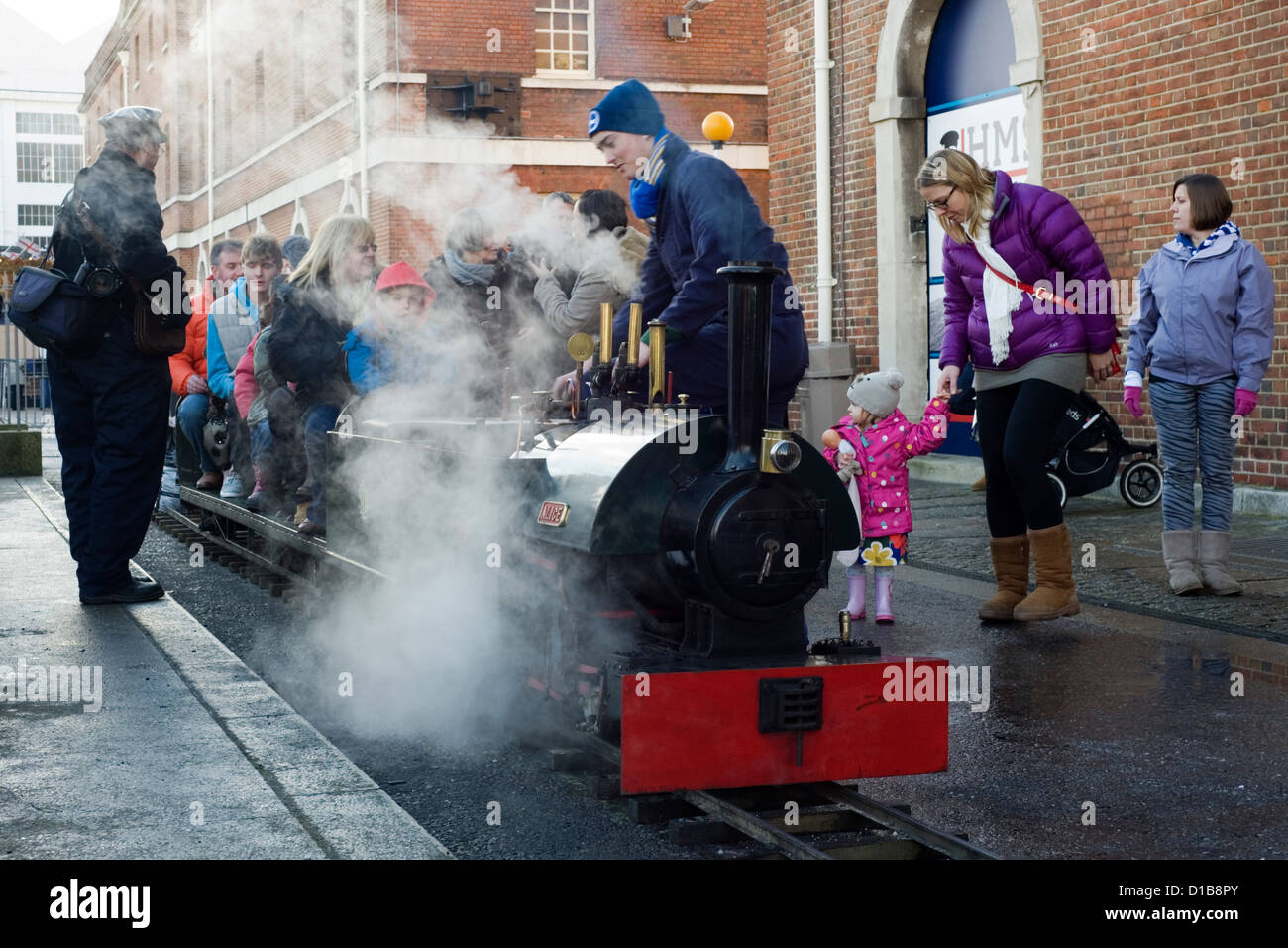 tourists ride on the model steam railway at the victorian festival of christmas portsmouth Stock Photo