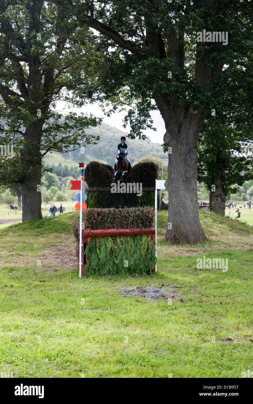 Female Riding a Brown Horse Jumping a Cross Country Fence at Blair Castle International Horse Trials Blair Atholl Scotland Stock Photo