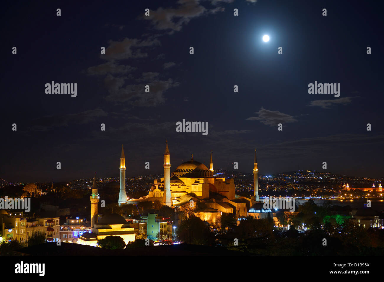Night lights on Hagia Sophia under a clear full moon rising at night in ...