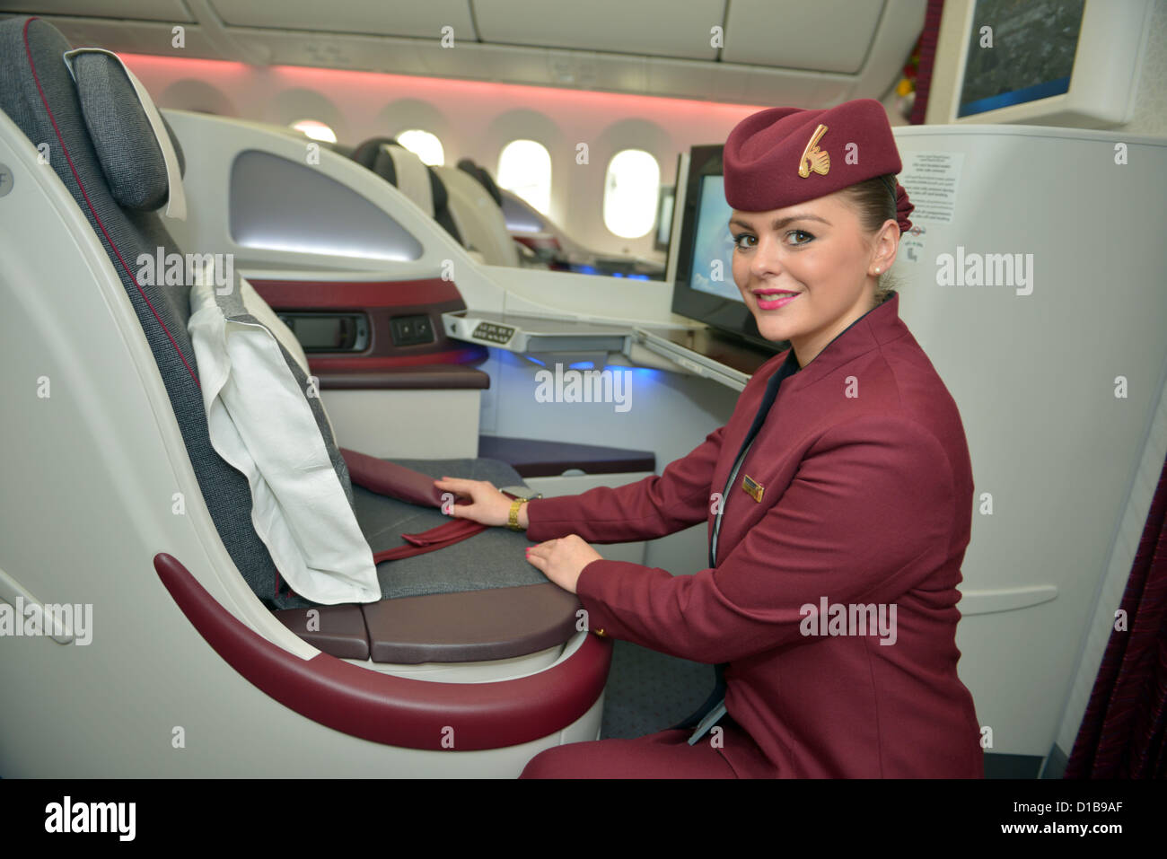 Qatar Dreamliner aircraft interior with stewardess, Business and First Class section Stock Photo