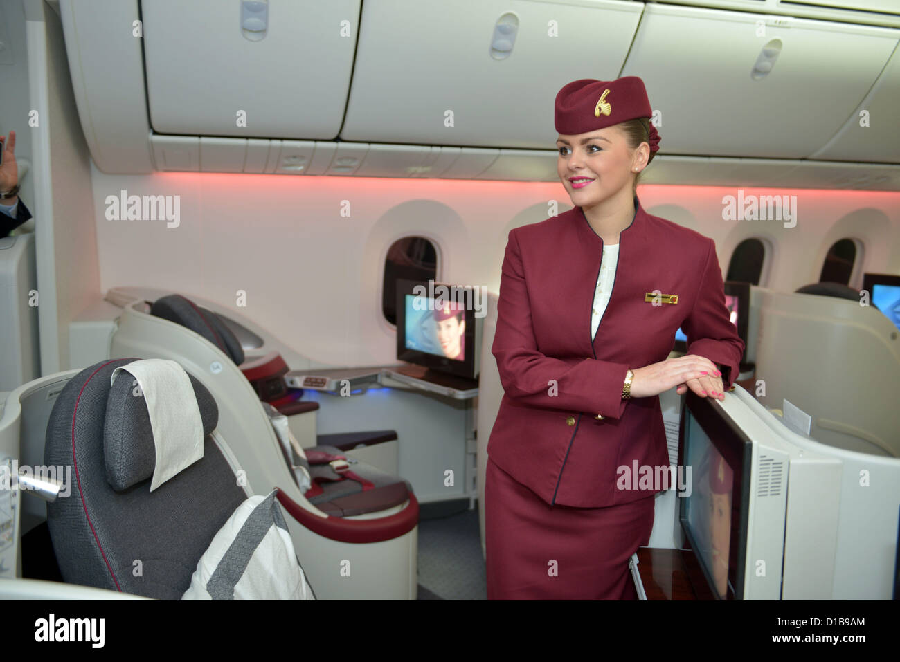 Qatar Dreamliner aircraft interior with stewardess, Business and First Class section Stock Photo