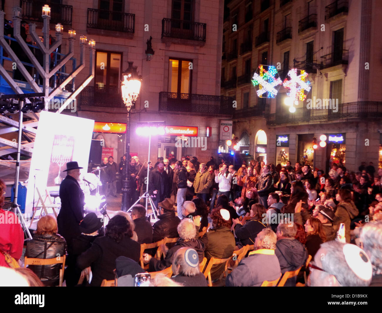 Jewish celebration of Hanukkah in Barcelona on December 13 in the Plaza Sant Jaume. A rabbi recited, one group has played music, sufganiyah were distributed freely and young people have danced. Stock Photo