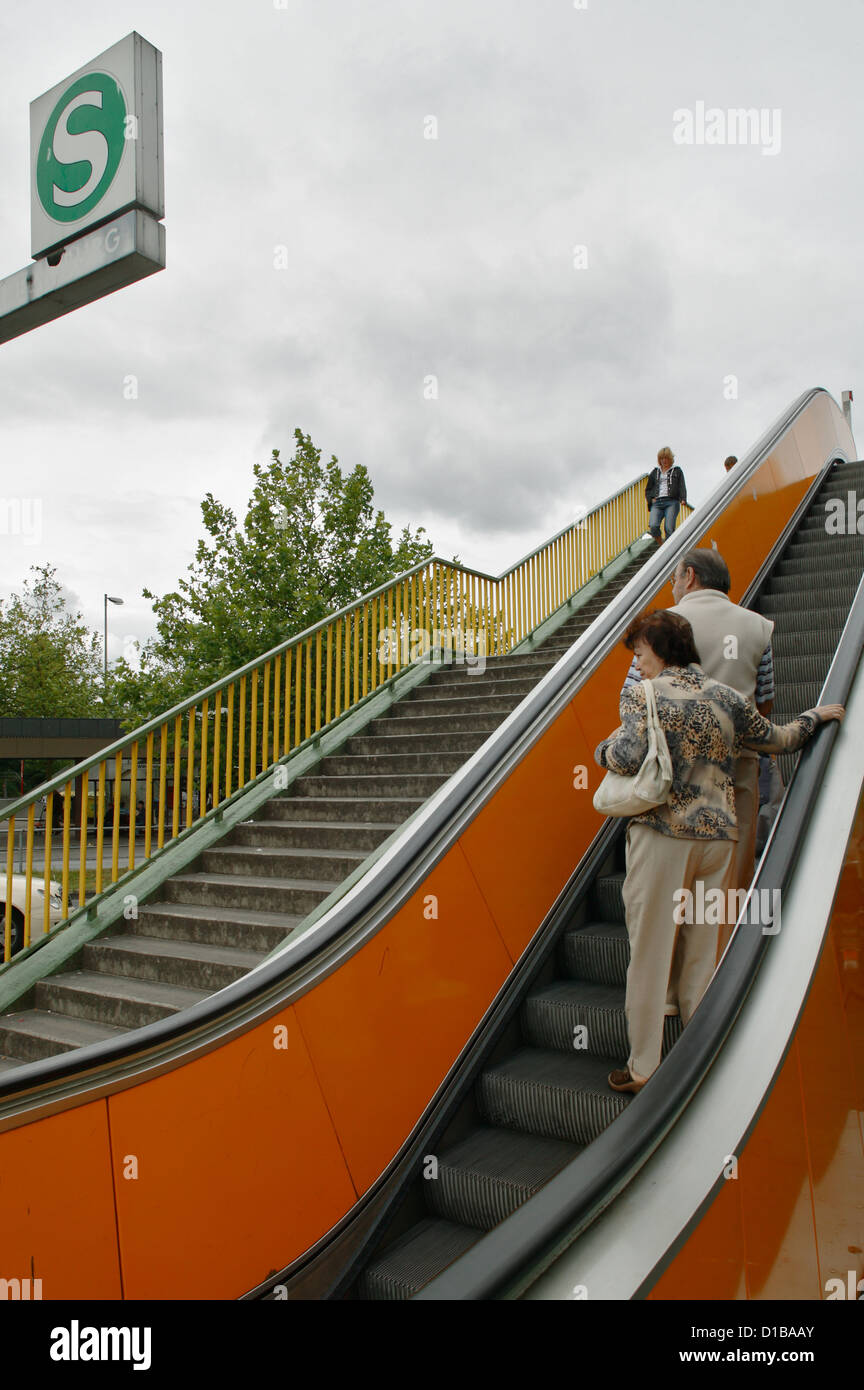 Hamburg, Germany, passersby on the escalator at the train station Wilhelmsburg Stock Photo