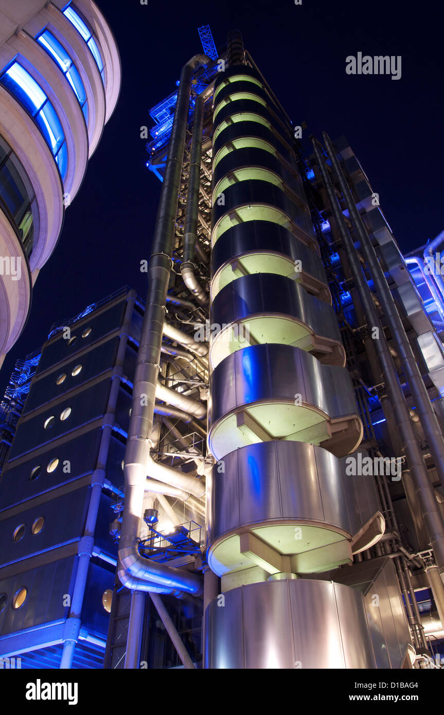 The iconic Lloyds Building, home of the insurance institution Lloyds of London, designed by Richard Rogers, illuminated by night. England, UK. Stock Photo