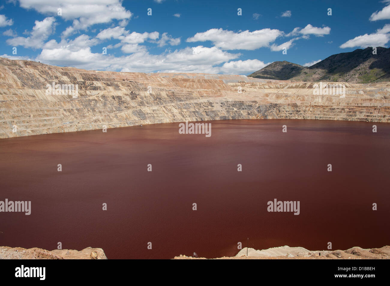 The discolored water of the Berkeley Pit in Butte, Montana.  The water is contaminated from the minerals in the open pit mining. Stock Photo
