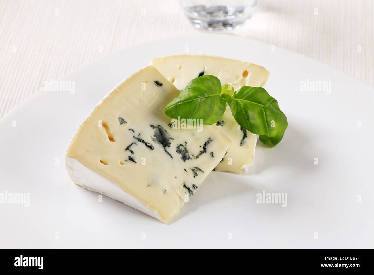 Wedges of blue cheese with white rind Stock Photo