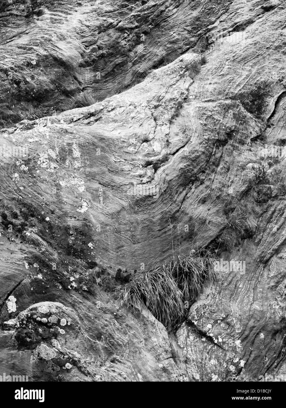 Black & white (B&W) rendition of a color photograph of granite folds in Milford Sound (Piopiotahi), Fiordland National Park, New Stock Photo