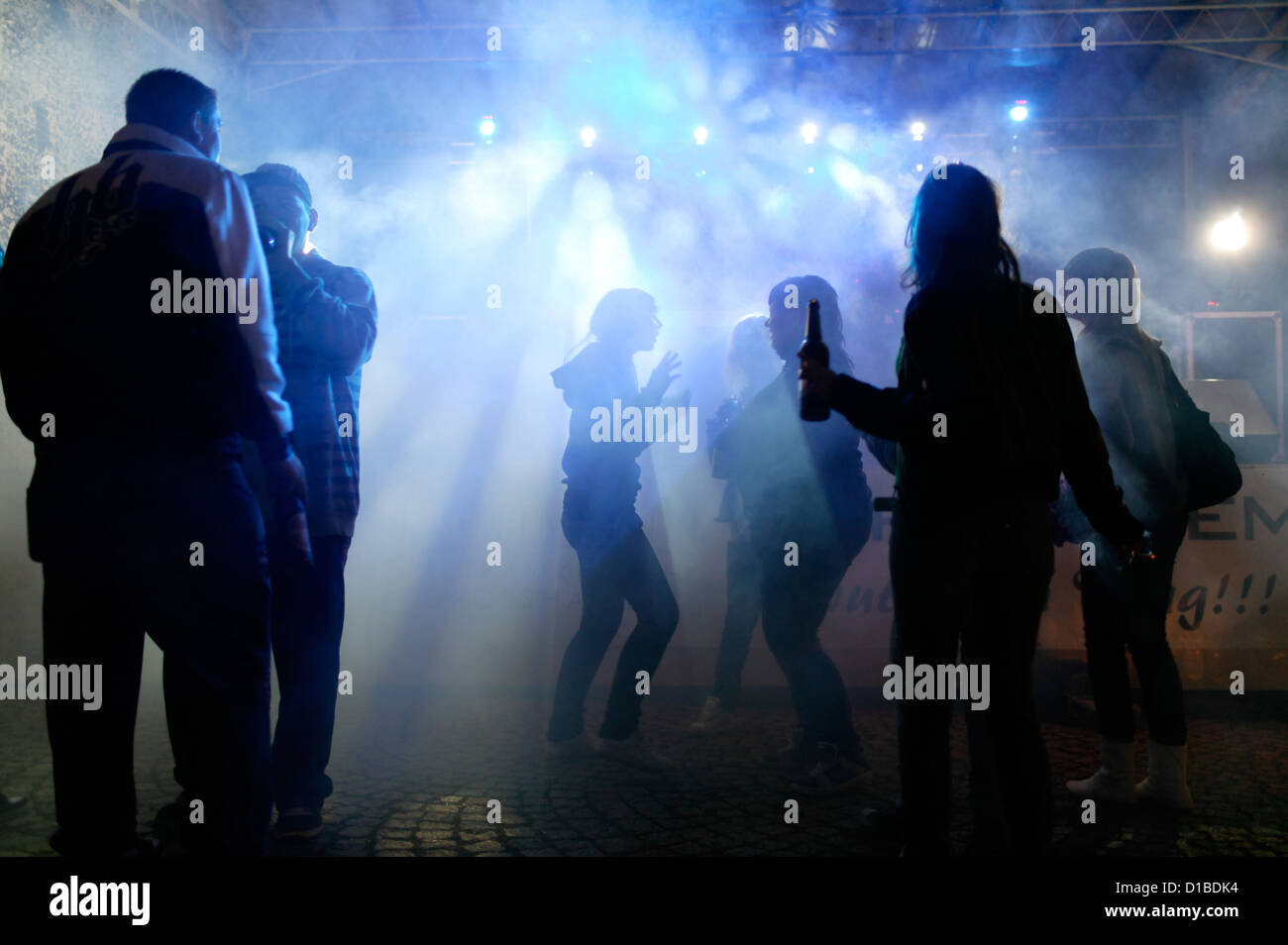 Sangerhausen, Germany, dancing and drinking adolescents in the spotlight Stock Photo