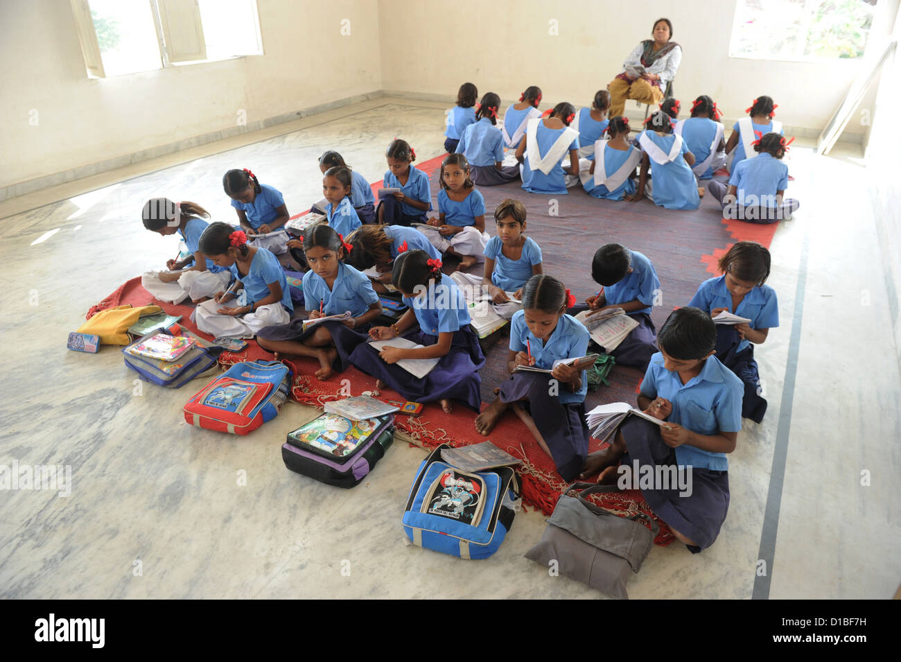 Students Of Two Classes Sit On The Floor Of A Classroom In The