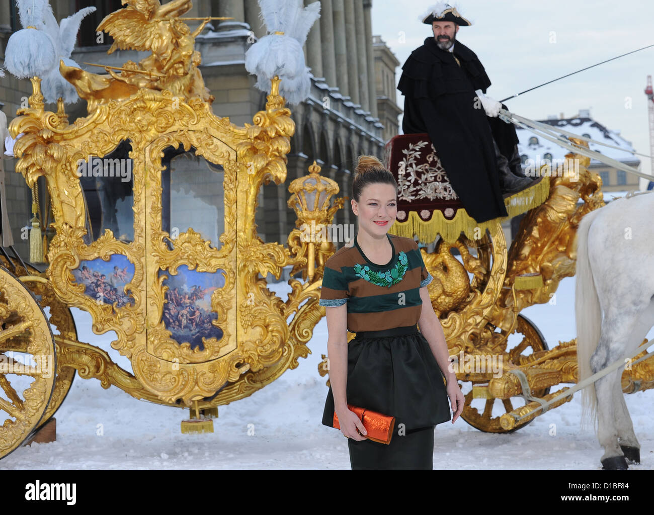 Lead actress Hannah Herzsprung (Elisabeth, Empress of Austria) stands in front of the golden coach from the movie for the premiere of the historical film 'Ludwig II' in the Hofgarten in Munich, Germany, 13 December 2012. The movie comes to cinemas on 26 December 2012 in Germany. Photo: URSULA DUEREN Stock Photo