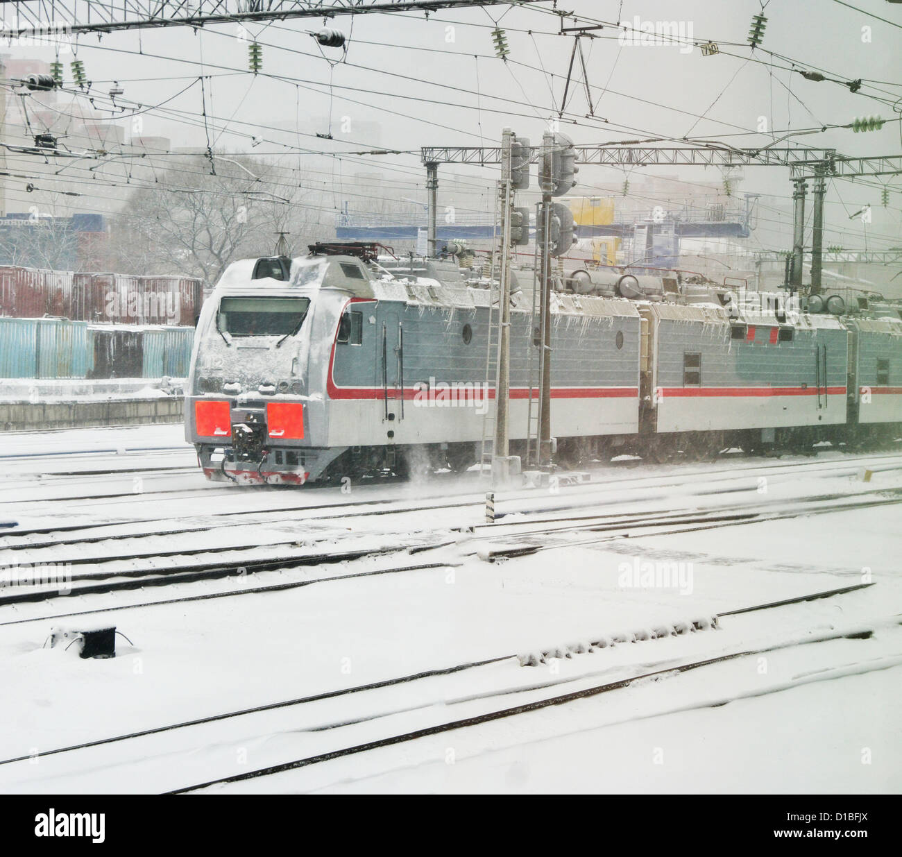 Proceeds electric locomotive station in snowy weather Stock Photo