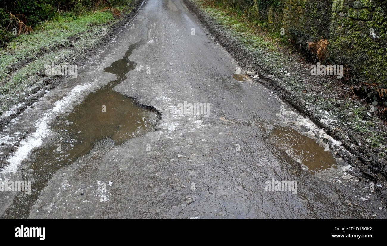 Potholes pot holes in a country lane road Stock Photo