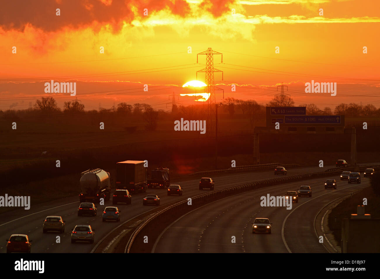 traffic travelling on the A1/M motorway at sunrise leeds uk Stock Photo