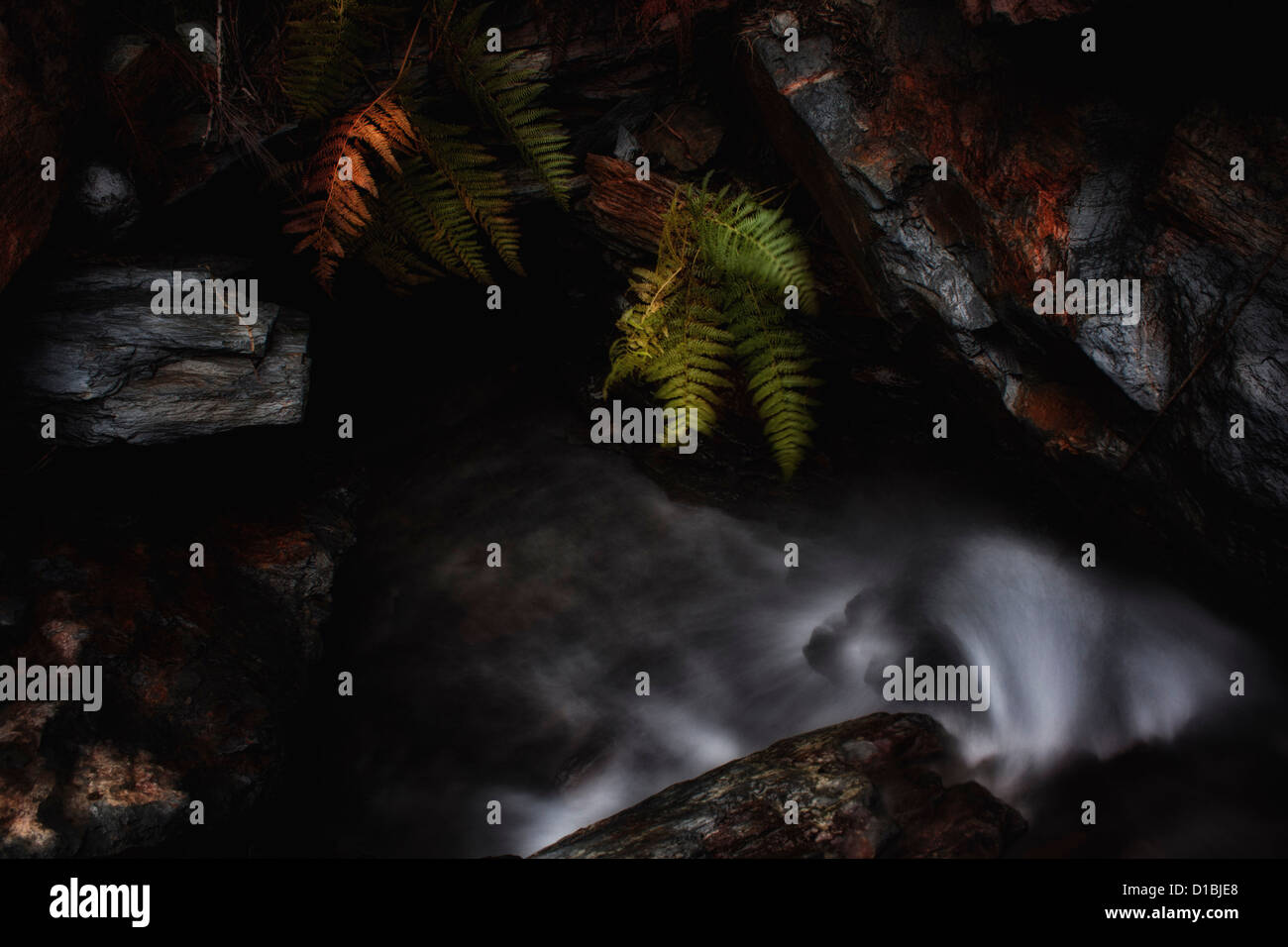 Small Waterfall Between Rocks Small waterfall between rocks in the mountains Stock Photo - Alamy