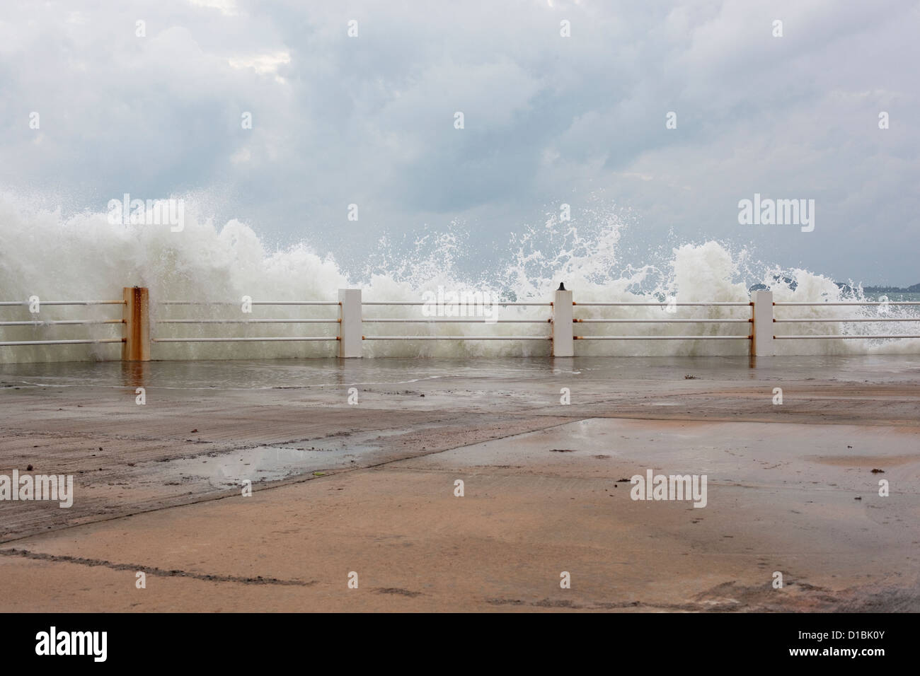 Waves crashing over barriers Stock Photo