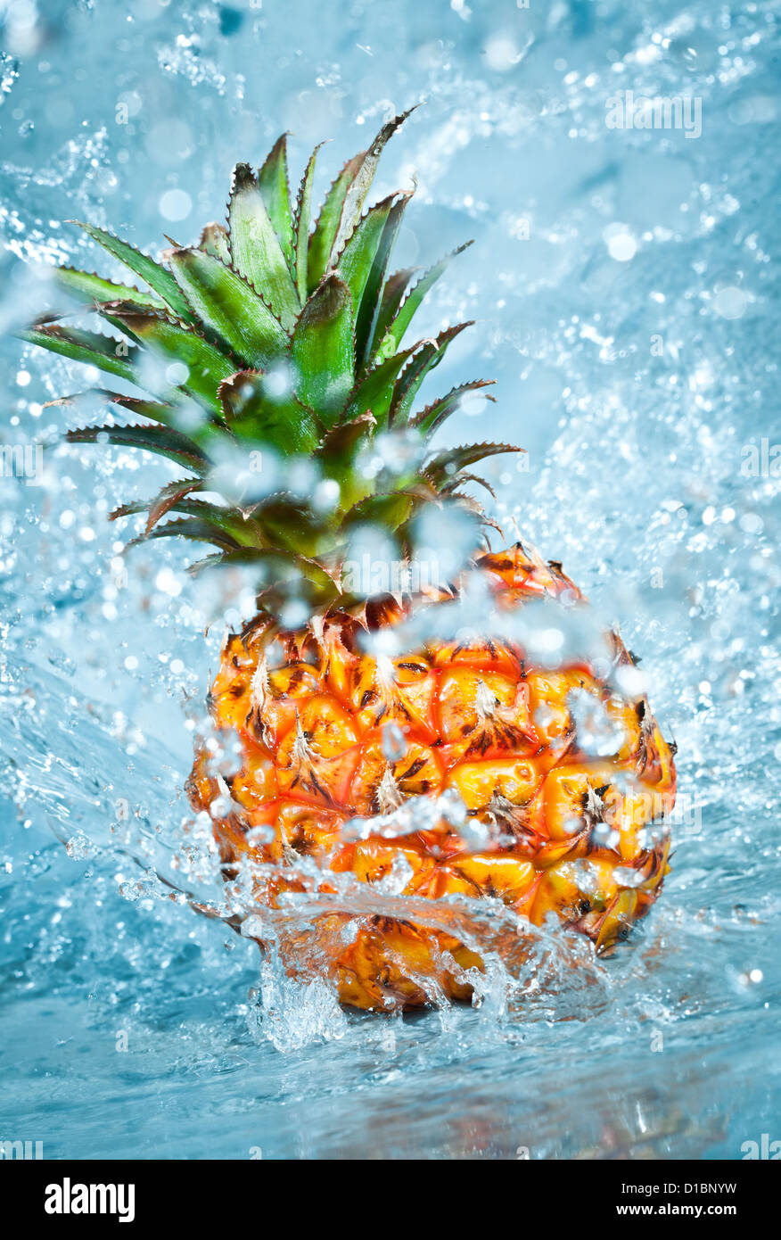 Fresh pineapple in water splashes Stock Photo