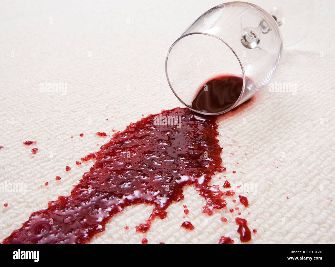 Red wine spilled on carpet. Stock Photo