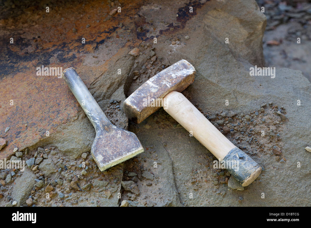 Stone masons tools, lump hammer and cold chisel on pennant sandstone Stock Photo