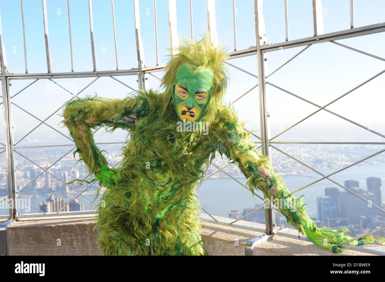 Dec. 14, 2012 - Manhattan, New York, U.S. - THE GRINCH looks over the Empire State Building's 86th floor observatory to celebrate the opening day of ''Dr. Seuss' How The Grinch Stole Christmas! The Musical'' on stage at The Theater at Madison Square Garden. (Credit Image: © Bryan Smith/ZUMAPRESS.com) Stock Photo