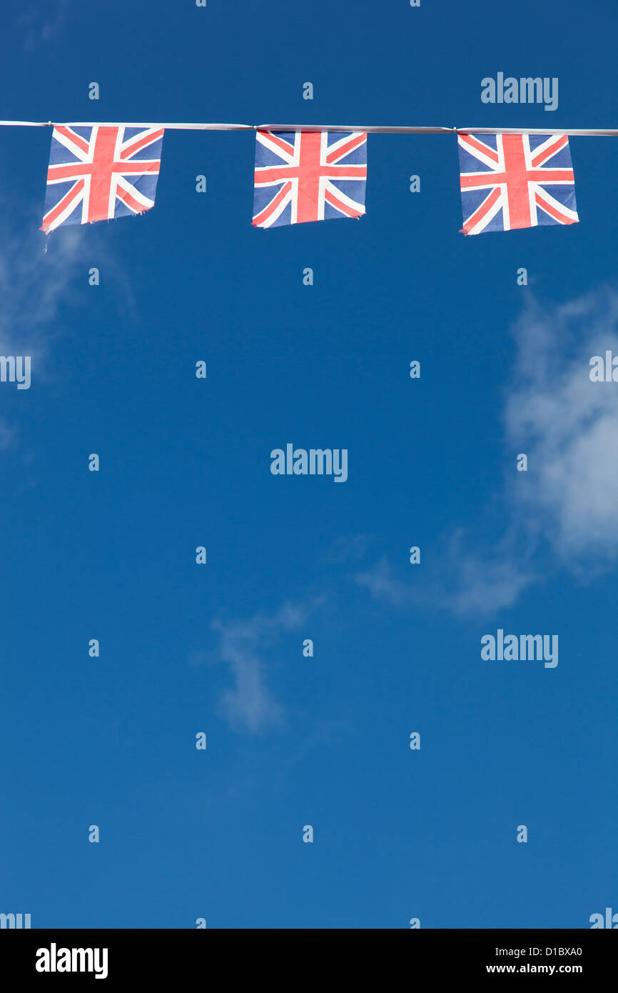 String of Union flags against a blue sky Stock Photo Alamy