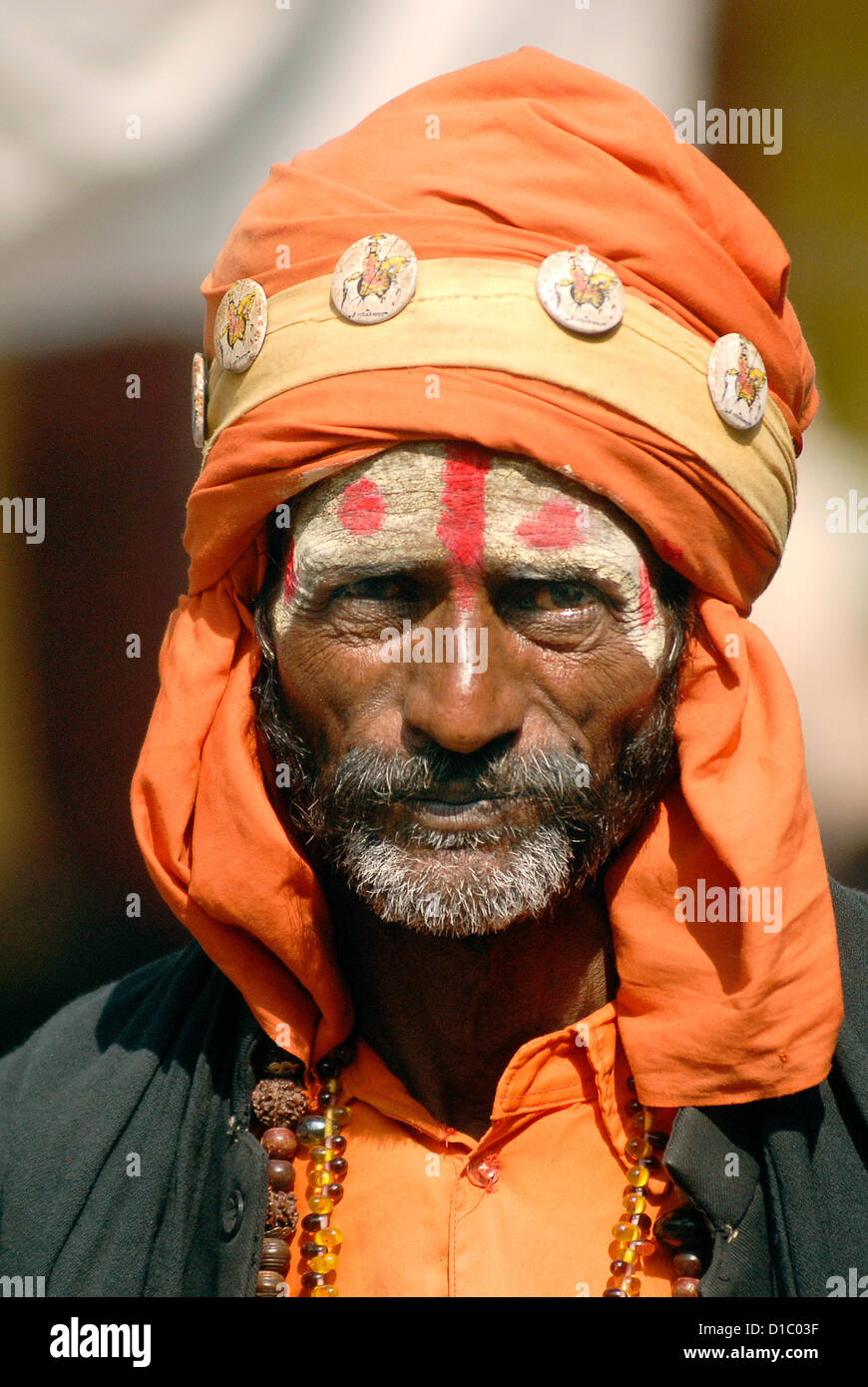 India, Rajasthan, Pushkar. A man wears the orange clothing of Sadhus in