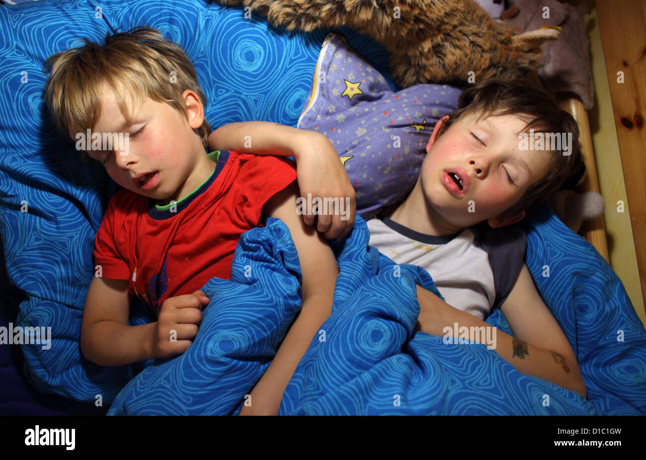 Berlin, Germany, children sleep together in one bed Stock Photo Alamy