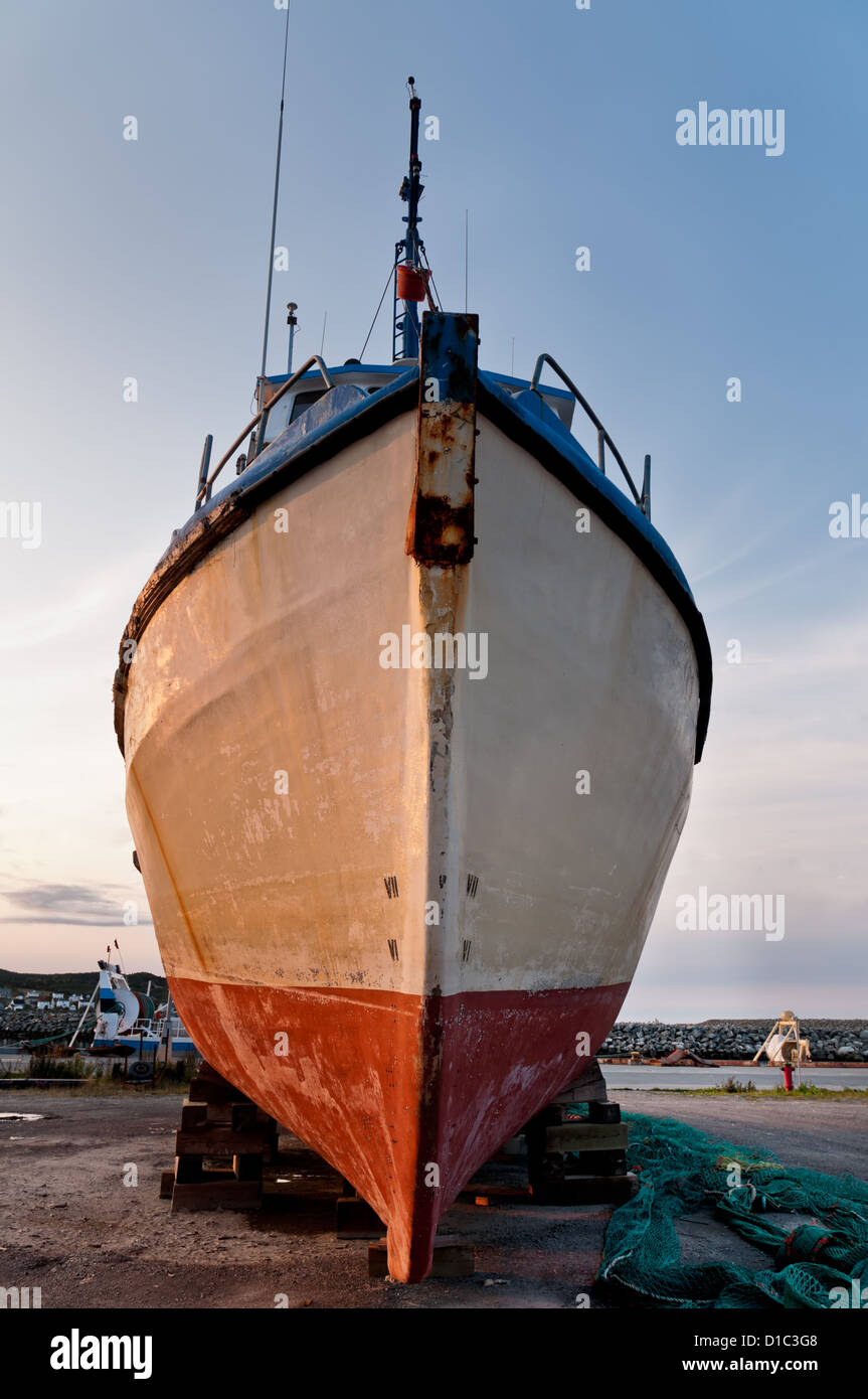 Fish trawler on land during off peak season, ship goes through maintenance Stock Photo