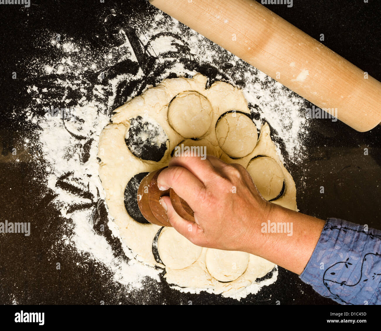 Baker cutting biscuit blanks from rolled dough Stock Photo Alamy