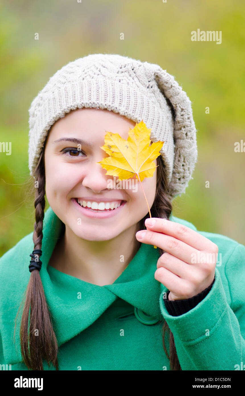 A happy girl with some leafs in her hands Stock Photo