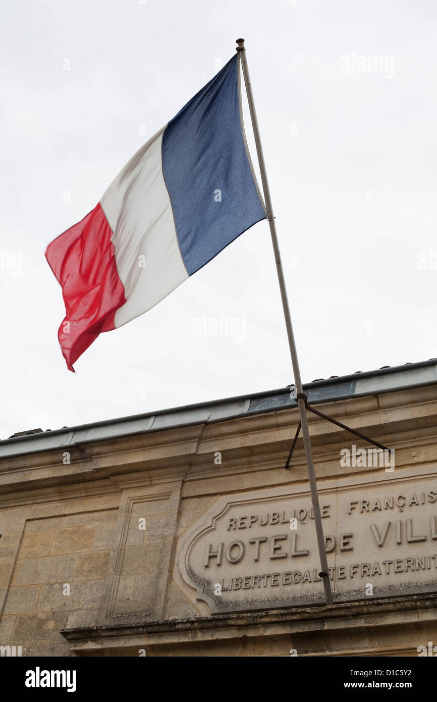 French flag flying above the Hotel De Ville, St Emilion, France Stock Photo