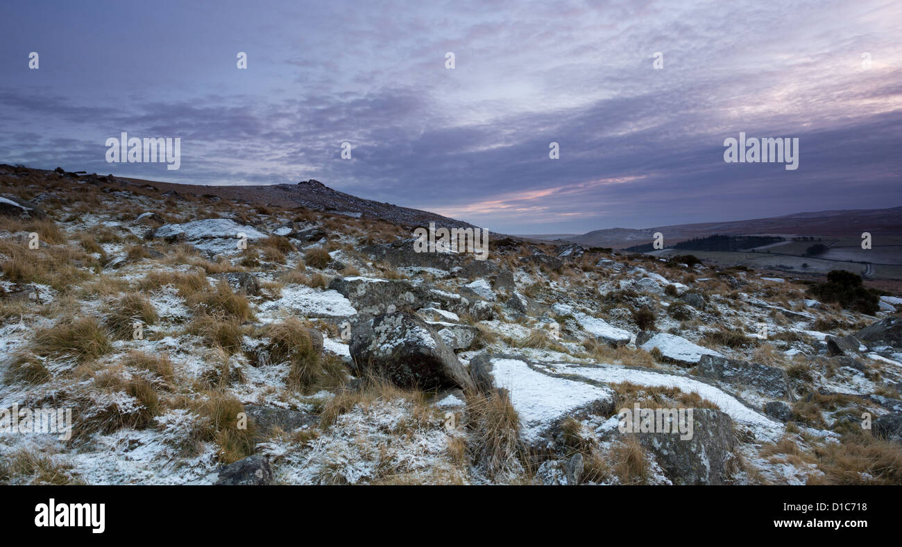 The lower slope of Belstone tor covered with a light dusting of snow at sunset. Dartmoor National Park Devon Uk Stock Photo