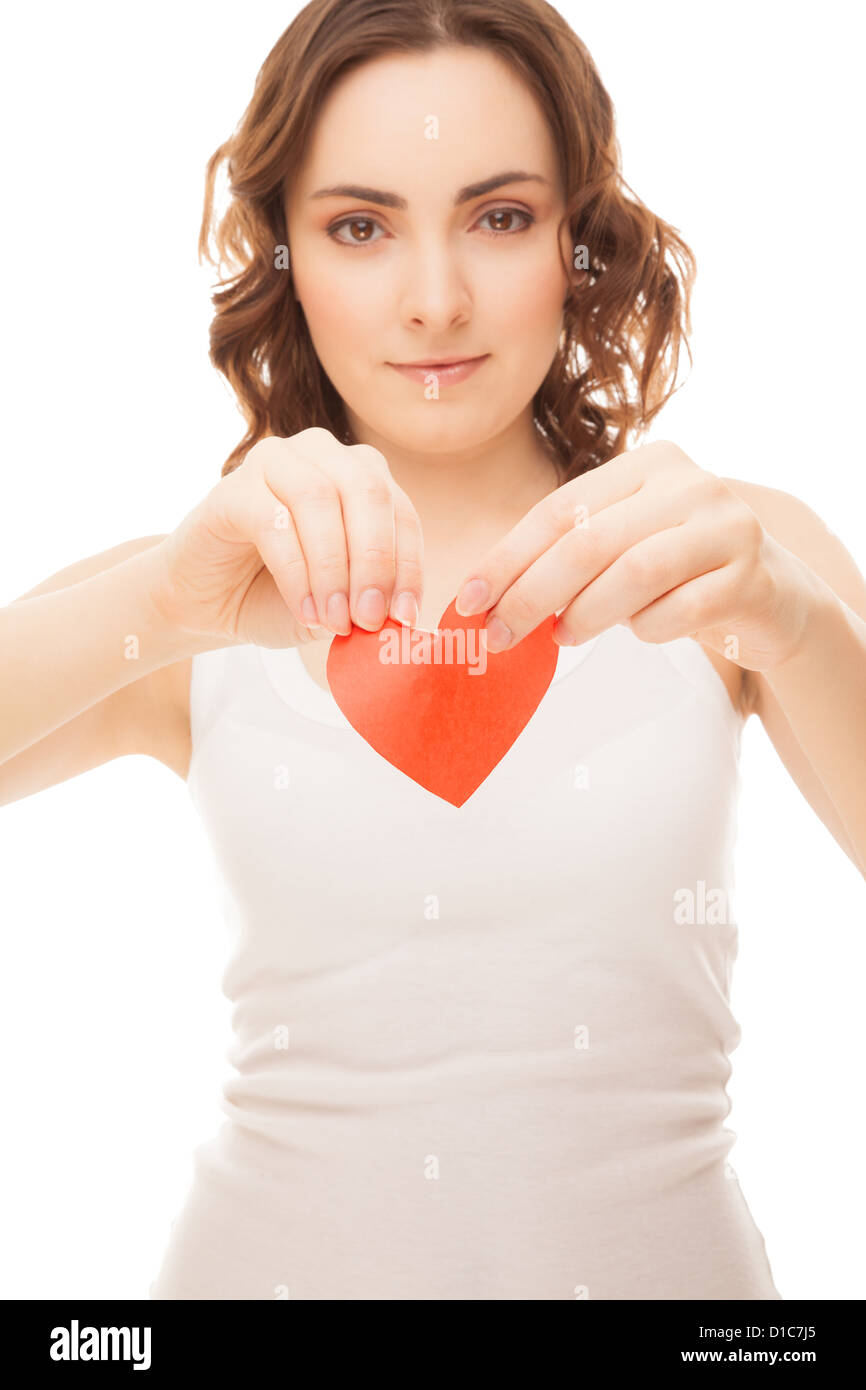 Attractive brunette young girl holding broken paper red valentine heart ...