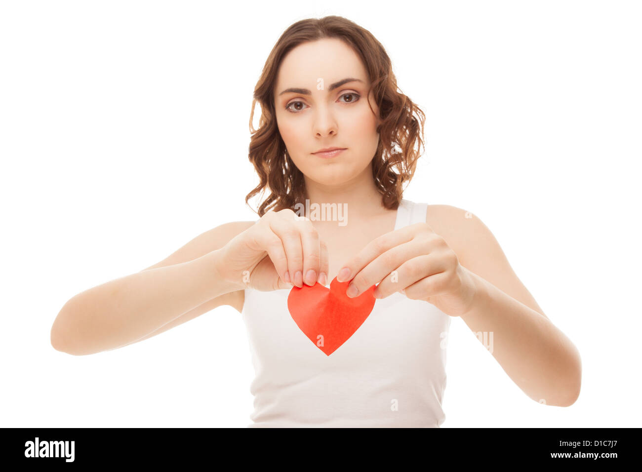 Attractive brunette young girl holding broken paper red valentine heart ...