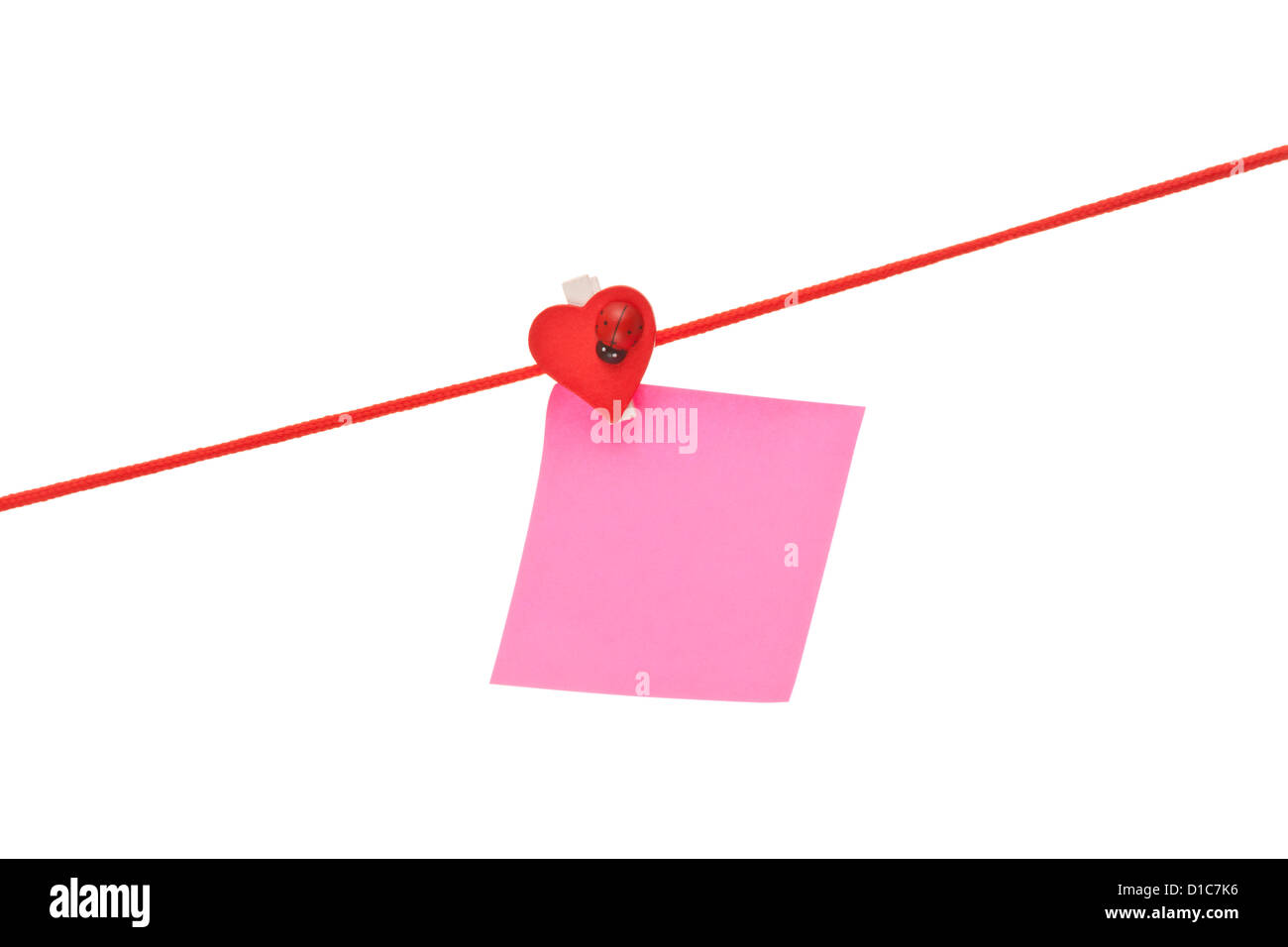 Pink sticky hanged on red rope isolated on white Stock Photo - Alamy