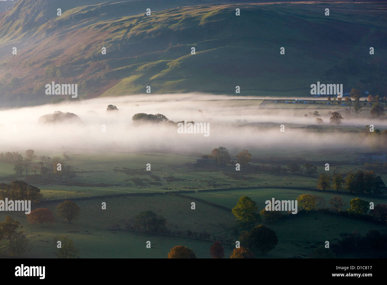 View from Latrigg summit towards mist over fields, Lake District National Park. Stock Photo