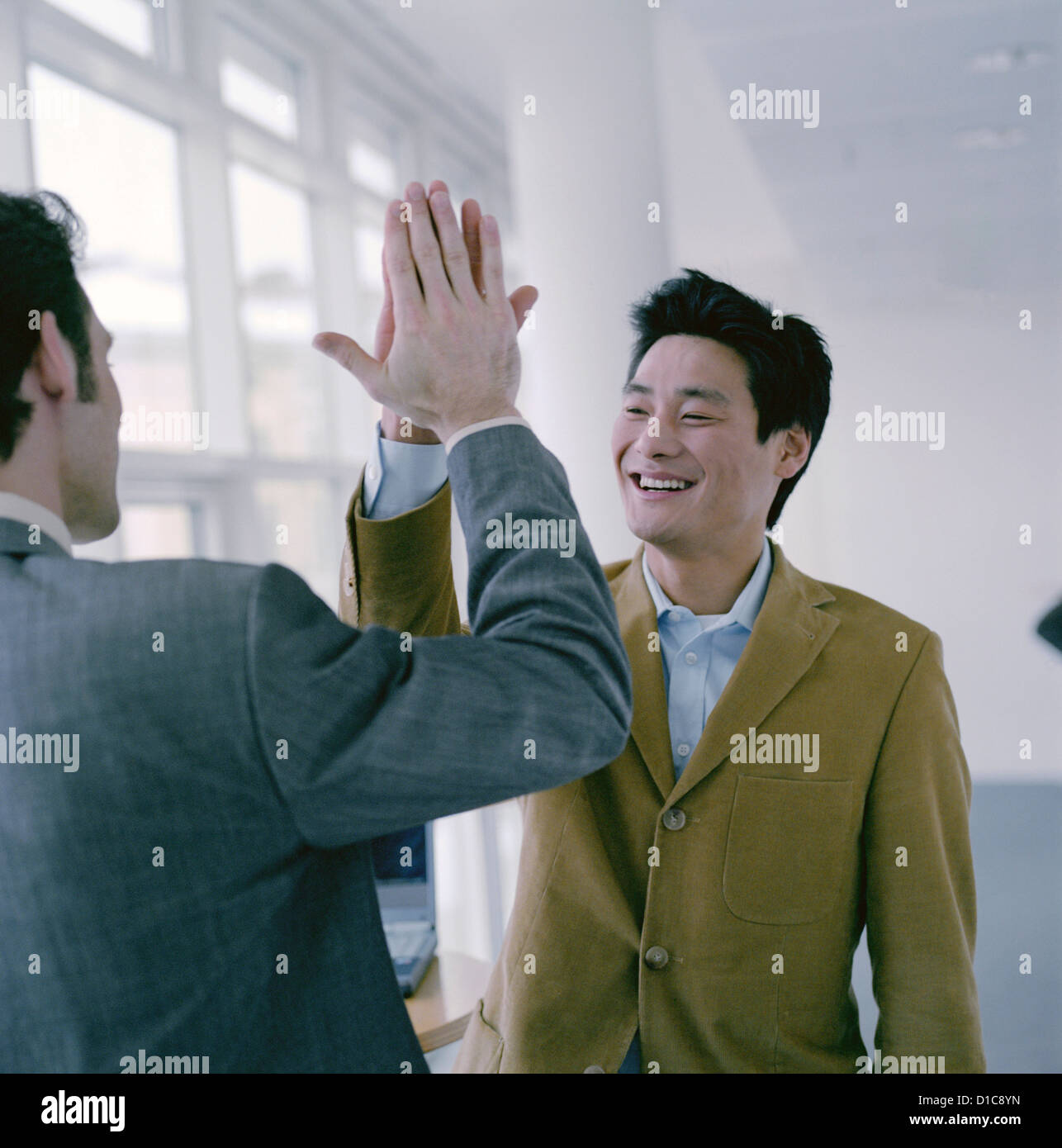 Two business people to give so a high five License free except ads and billboards Stock Photo