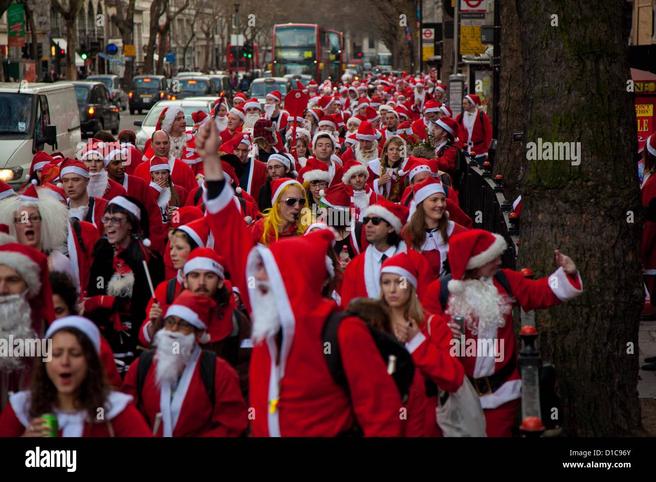 London, UK. 15th of December 2012 Annual Santa Con gathering hits Central London. Every year in December thousands of people dress up as Santa for the annual get together of Santa Con, they walk from various landmarks in London before ending in Trafalgar Square. Credit:  nelson pereira / Alamy Live News Stock Photo