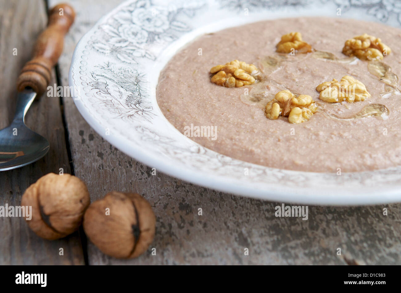 Creamy black salsify and walnut soup in a soup bowl. Stock Photo