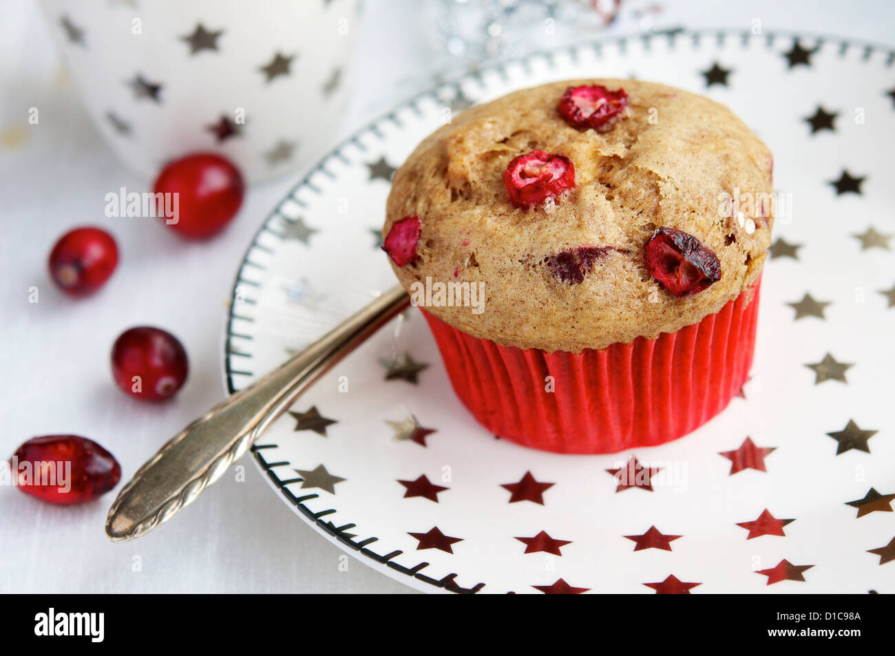 Apple and cranberry muffin (vegan) on a plate with silver stars. Stock Photo