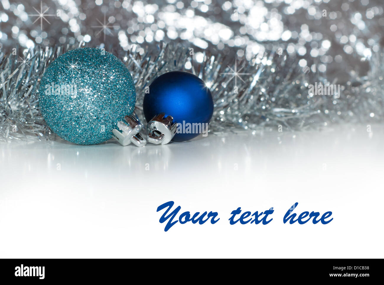 Christmas baubles with silver tinsel and silver bokeh background, with ...