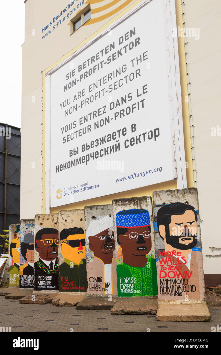 Street scene with remaining sections of the wall painted with pictures depicting a portrait of world dictators on Friedrichstrasse, Berlin, Germany Stock Photo