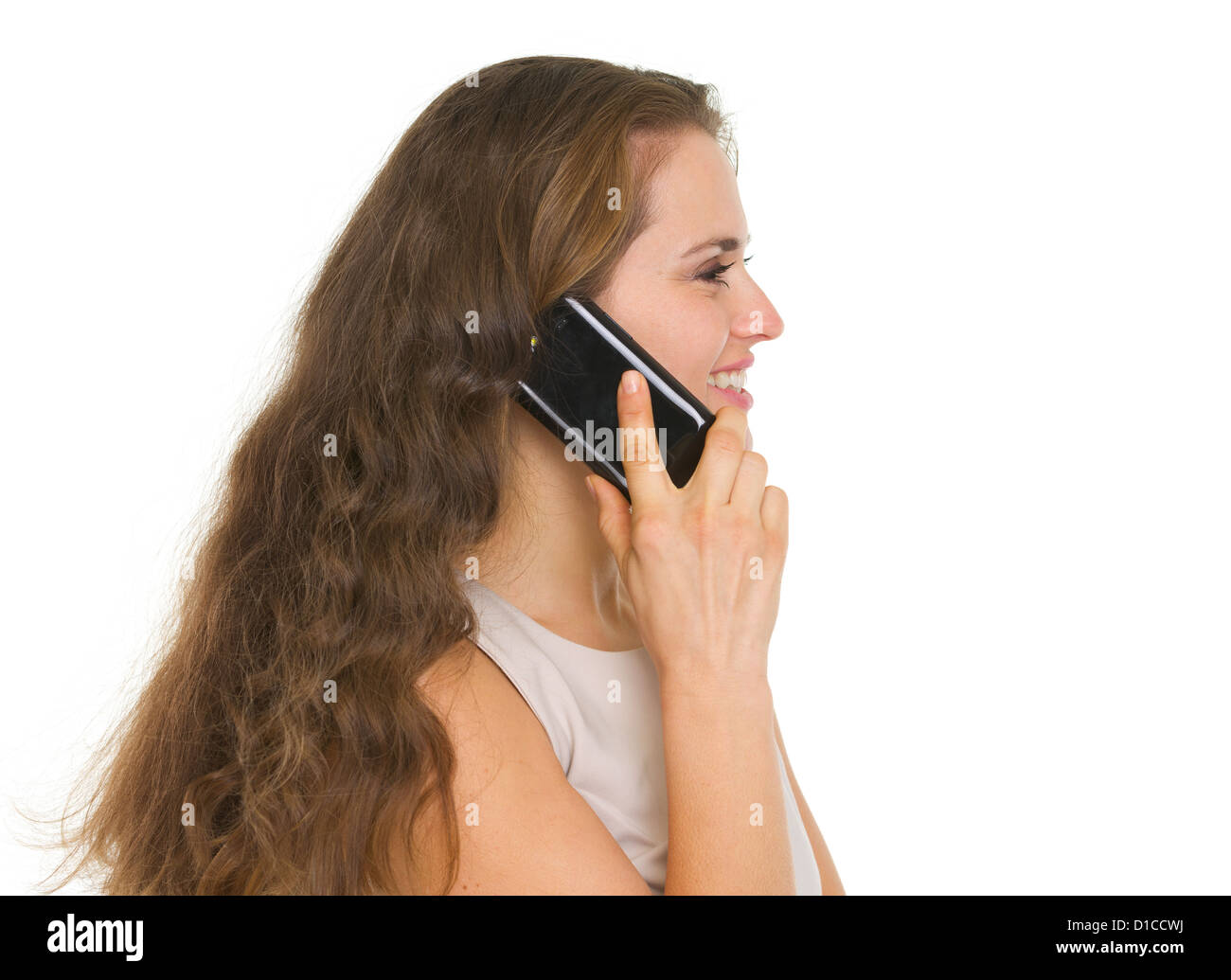 Smiling woman talking mobile phone. Side view Stock Photo