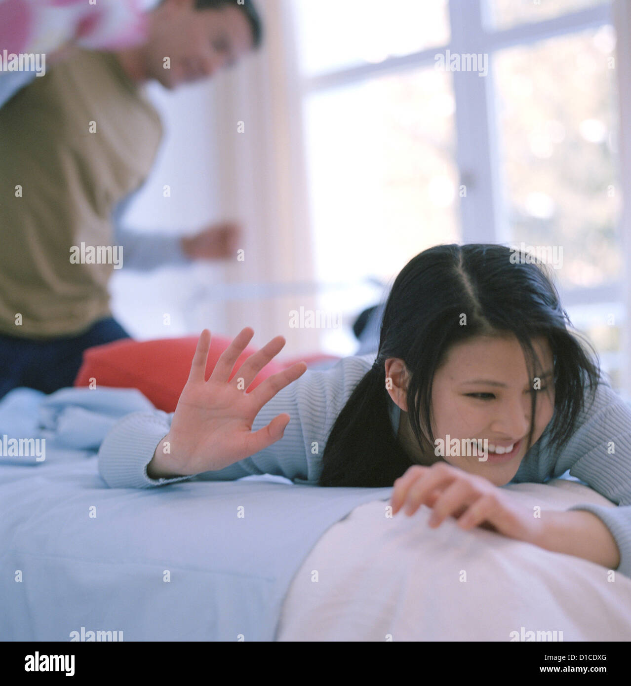 two people playing in the bed License free except ads and billboards Stock Photo