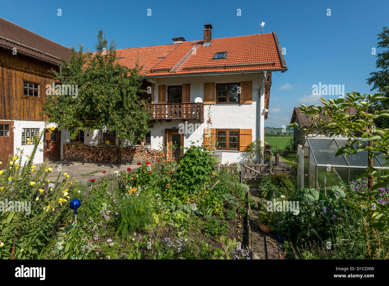 Traditional Upper Bavarian Farmhouse with cottage garden Stock Photo