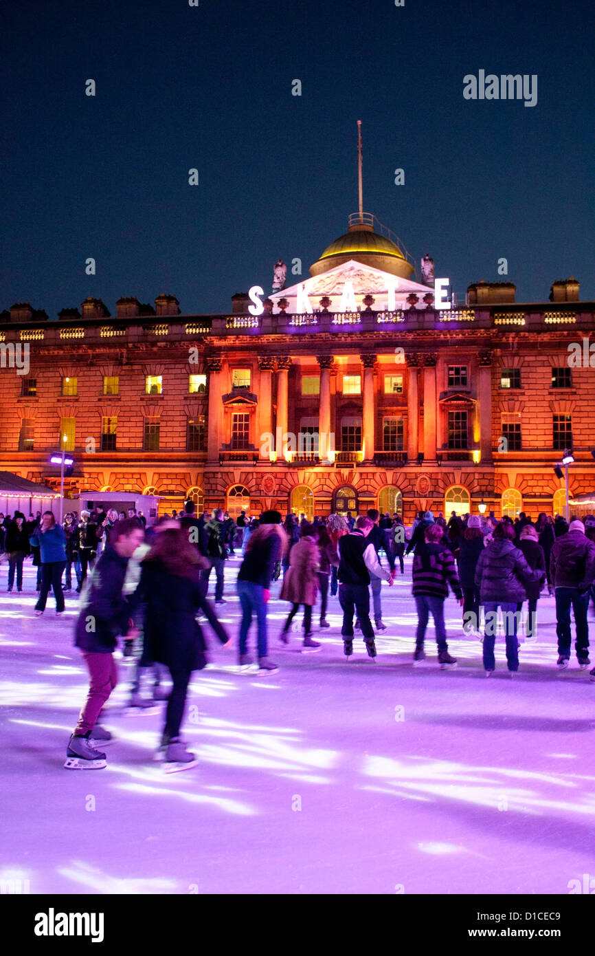 Ice skaters at rink at Somerset House at night Strand London England UK ...