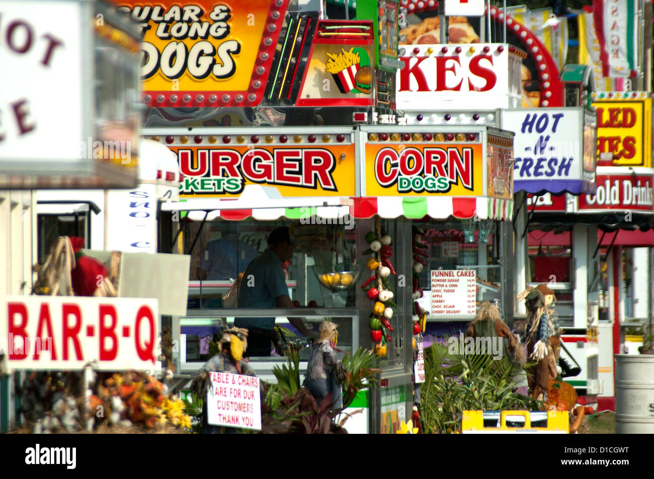 A photograph of concession stands in a row in a fairground setting