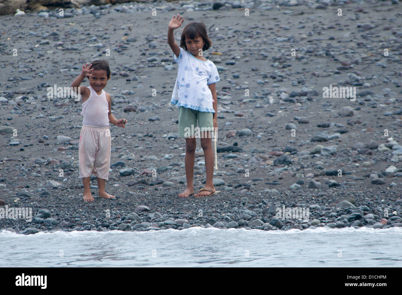 Children waving, Makian Island, Spice Islands, Maluku Region, Halmahera, Indonesia, Pacific Ocean (No MR) Stock Photo